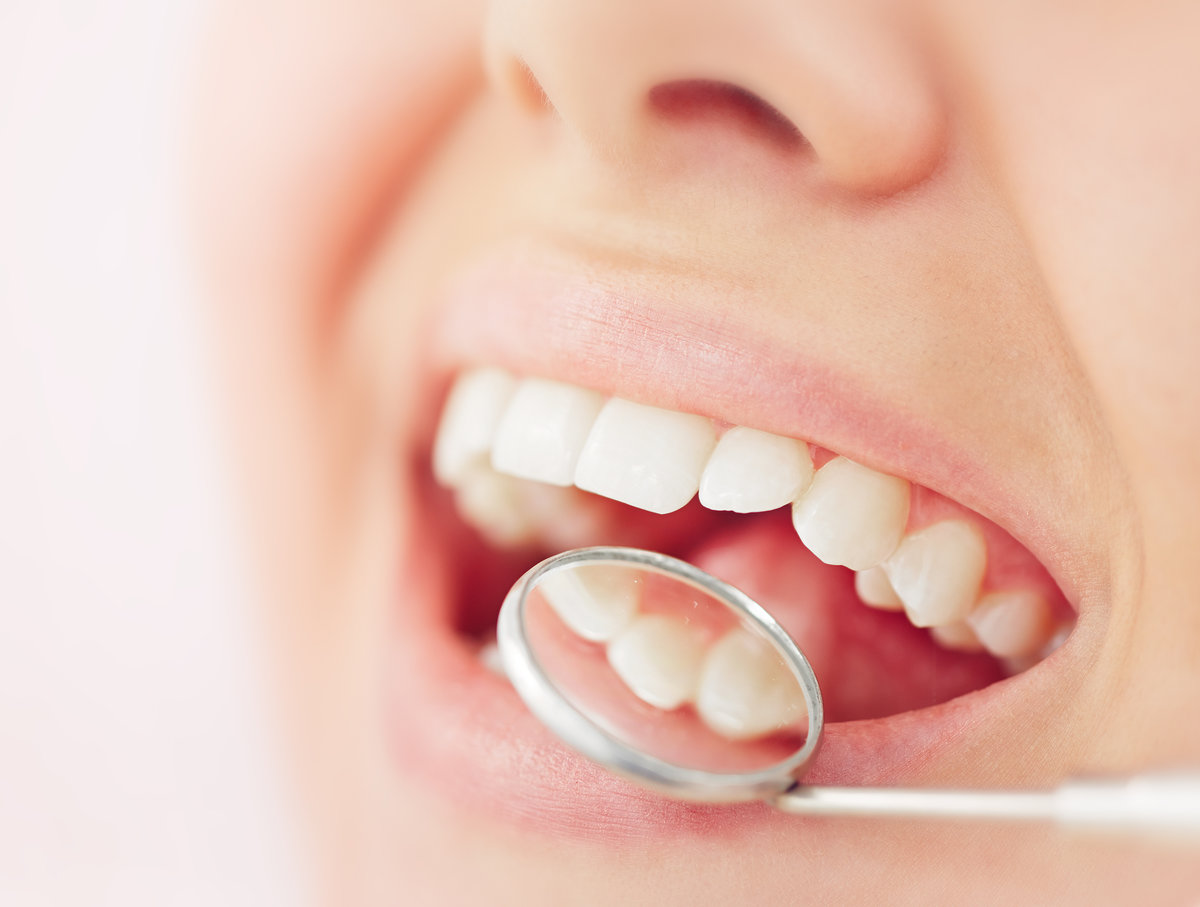 Open mouth and white teeth being checked up